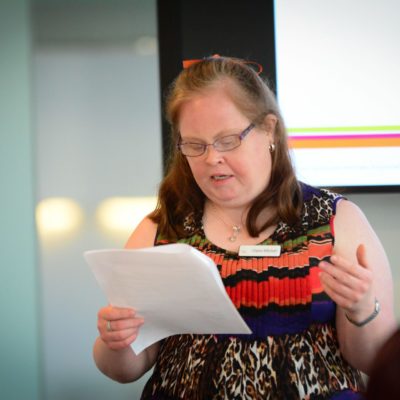 A woman with Down syndrome gives a speech