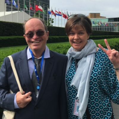 Rachel Spenser gives a peace sign alongside a colleague at the UN COSP