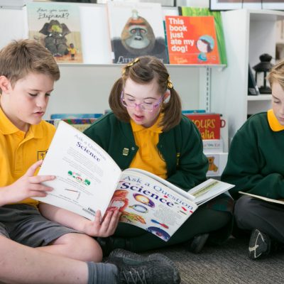 three children reading books