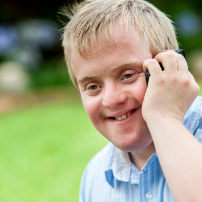A smiling man having a phone call