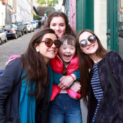 3 women and a girl smiling