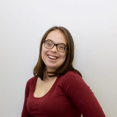 Woman in red shirt smiling.