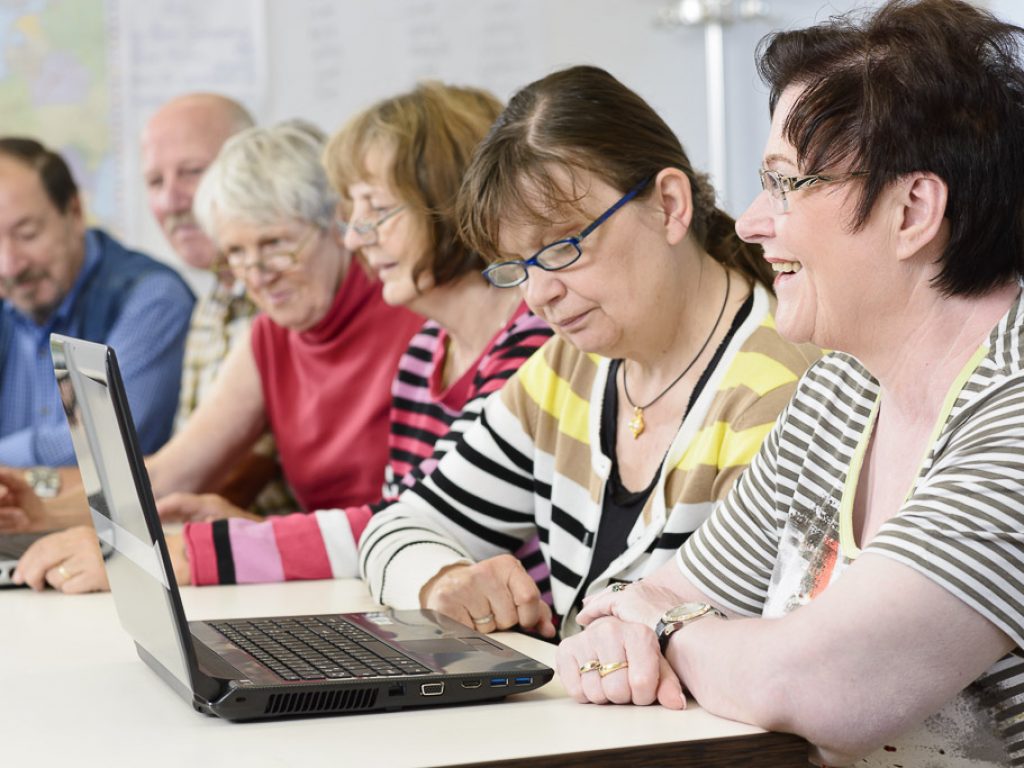 A group of people sit at a table learning