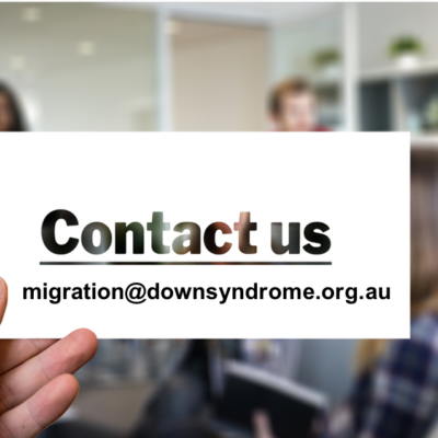 A hand holds a card with the email address migration@downsyndrome.org.au