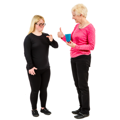 Two women stand talking