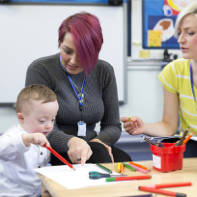 Teachers help a young child to learn