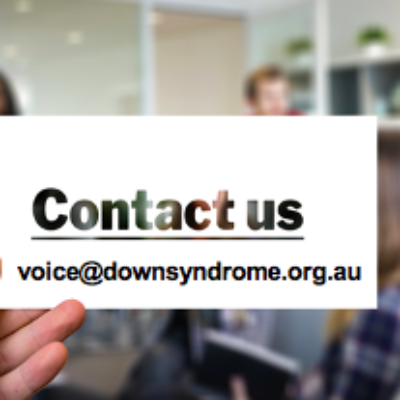 A hand holding a card with the email address voice@downsyndrome.org.au
