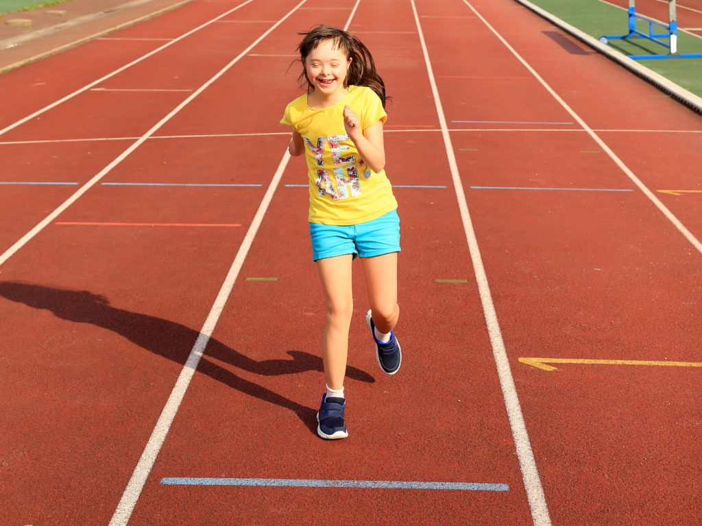 Girl running on a track.