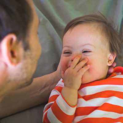 Baby boy playing with his dad