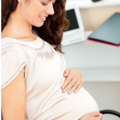 A pregnant woman touches her stomach