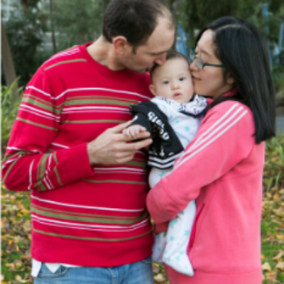 Parents hold their young son