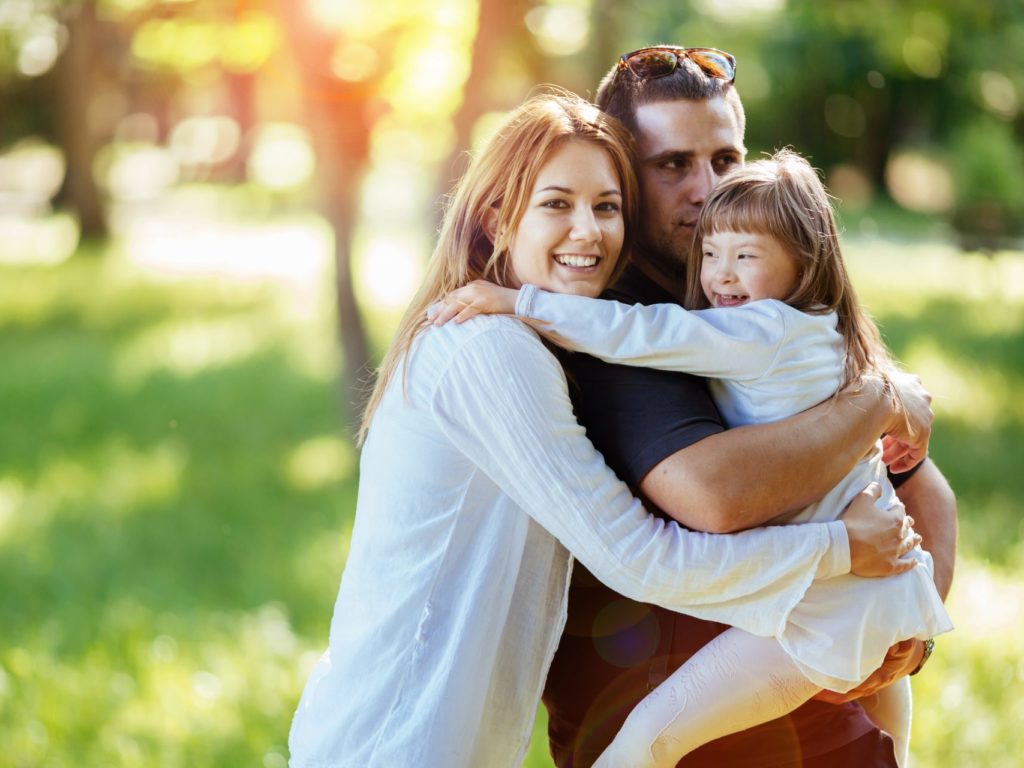 Family of 3 hugging each-other