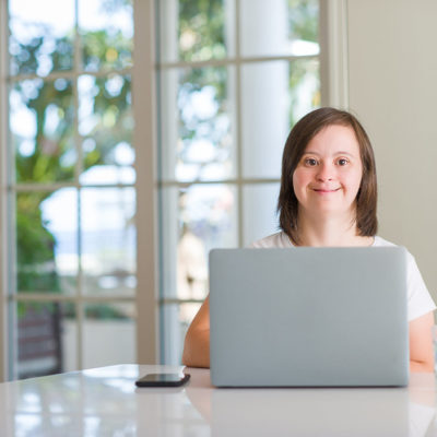 A woman with Down syndrome uses a computer