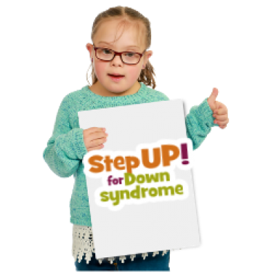 A young girl holding a sign saying Step UP