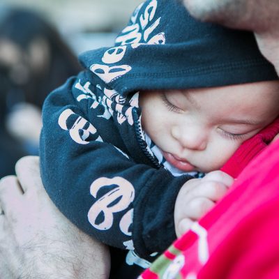 A parent holding a new baby