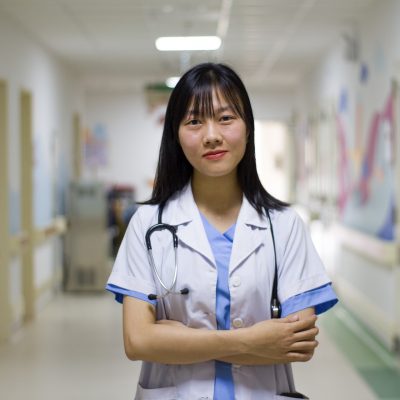 A nurse standing in a hospital corridor
