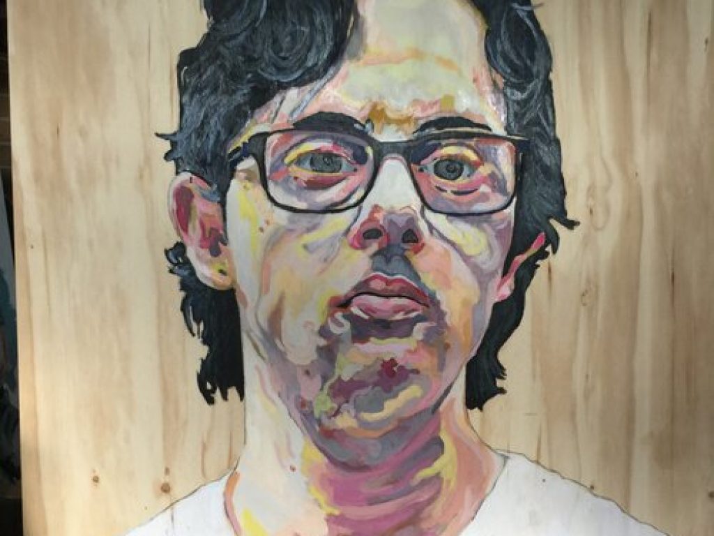 A finished painting of Nathan on wood.