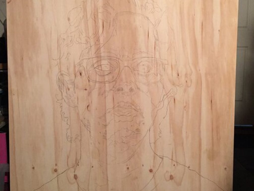 A drawing of Nathan on wood.