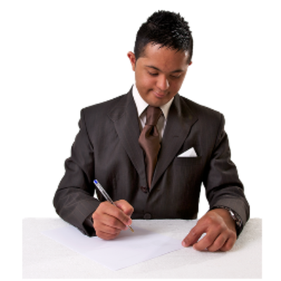 A man sits at a table writing