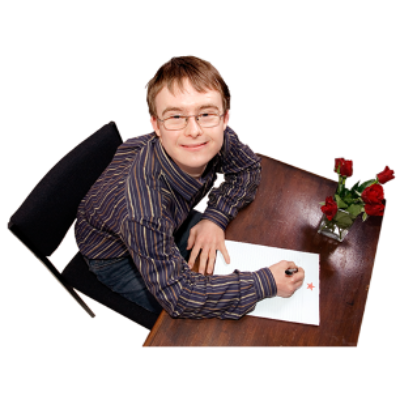 A man sits at a desk writing