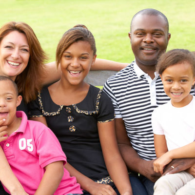 A family sits together outdoors